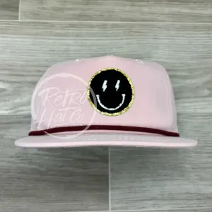 Black Smiley w/Gold Patch & Lightning Eyes on Blush Retro hat w/Maroon Rope